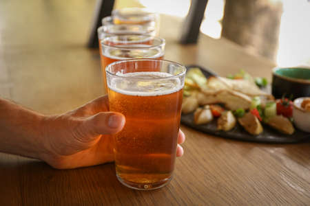 Man drinking fresh beer in pub, closeupの写真素材