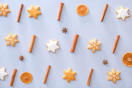 Tasty Christmas cookies, cinnamon and dry orange on light backgroundの写真素材
