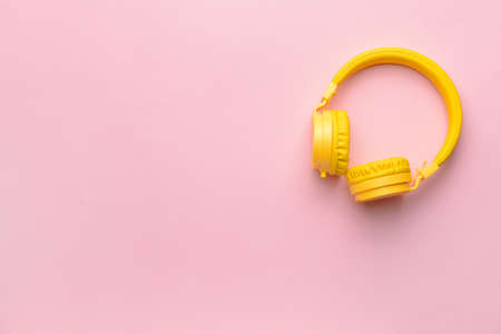 Modern headphones on color backgroundの写真素材