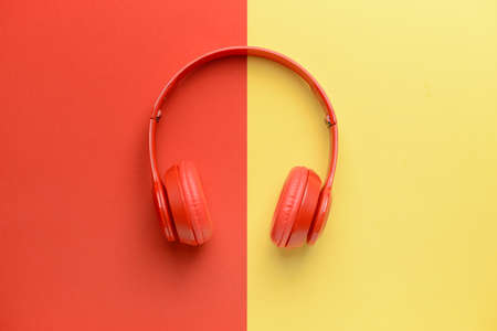 Modern headphones on color backgroundの写真素材