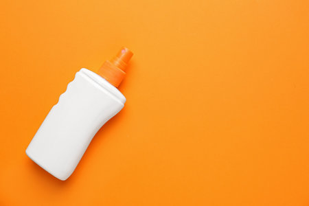 Bottle of sun protection cream on color backgroundの写真素材