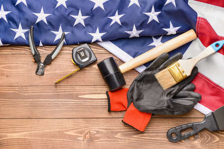 Set of tools and USA flag on wooden background. Labor Day celebrationの写真素材
