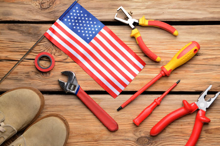 Set of tools and USA flag on wooden background. Labor Day celebrationの写真素材