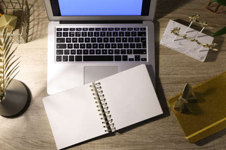 View of comfortable workplace with laptop in evening