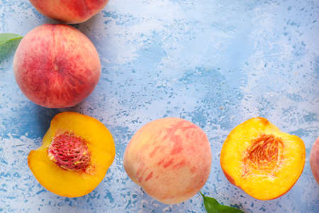 Ripe peaches on color backgroundの写真素材