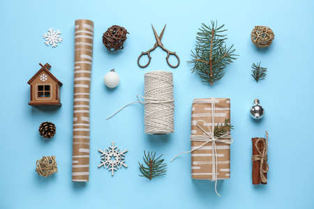Christmas gift box with decor on color background