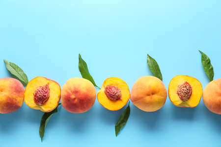 Ripe peaches on color backgroundの写真素材