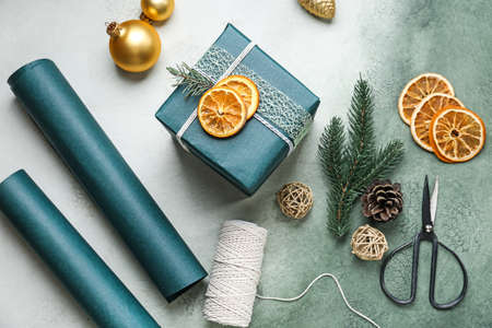 Beautiful Christmas gift box with supplies on color backgroundの写真素材