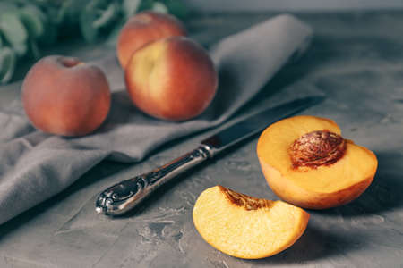 Tasty peaches with knife on grunge backgroundの写真素材