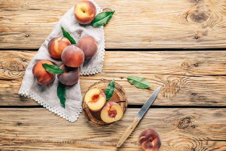 Tasty peaches on wooden table