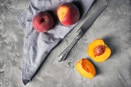 Tasty peaches with knife on grunge backgroundの写真素材