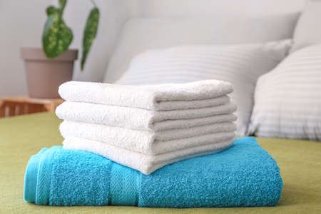 Clean soft towels on bedの写真素材