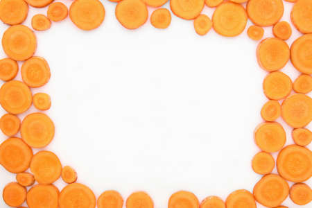 Frame made of tasty ripe carrot slices on white backgroundの写真素材