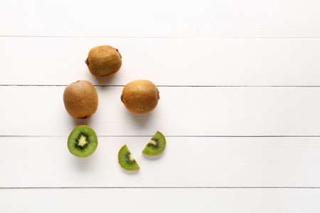 Tasty ripe kiwi on white wooden backgroundの写真素材