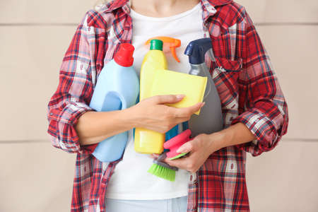 Woman with cleaning supplies in bathroom, closeupの写真素材