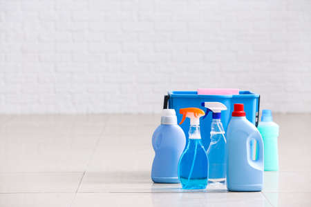 Set of cleaning supplies on floor in roomの写真素材