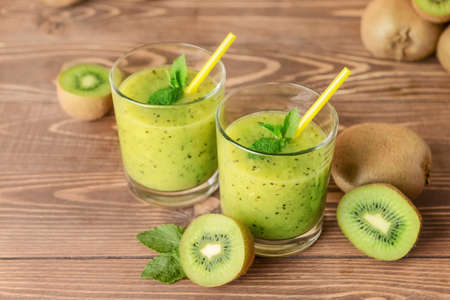 Glasses of tasty kiwi smoothie on tableの写真素材