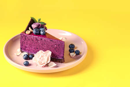Plate with tasty blueberry cake on color backgroundの写真素材