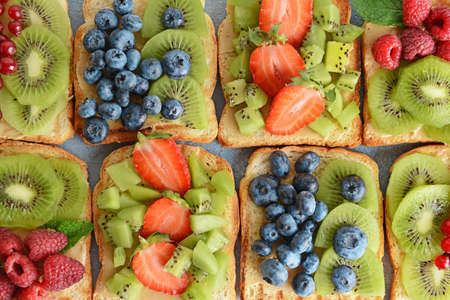 Tasty sandwiches with kiwi and berries, top viewの写真素材