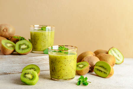 Glasses of tasty kiwi smoothie on tableの写真素材