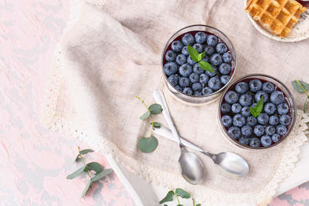 Glasses with blueberry dessert on tableの写真素材