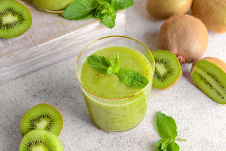 Glass of tasty kiwi smoothie on tableの写真素材