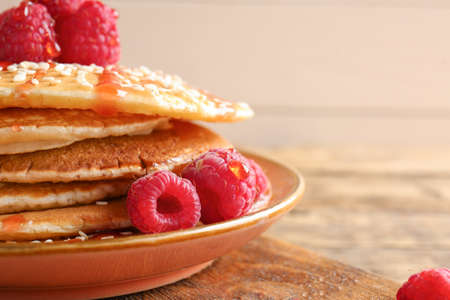 Plate with tasty pancakes and berries on table, closeupの写真素材
