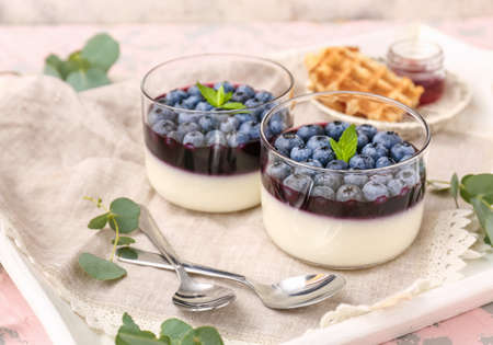 Glasses with blueberry dessert on trayの写真素材