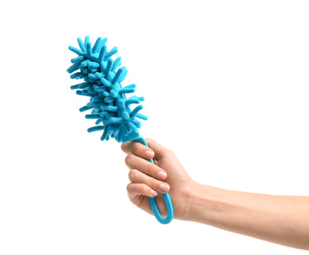 Female hand holding dust brush on white background