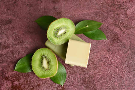 Soap bars with kiwi on color backgroundの写真素材