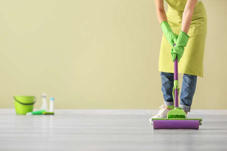 Woman cleaning floor in roomの写真素材