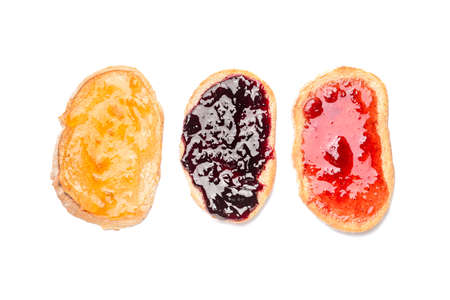Tasty toasted bread with different jams on white background