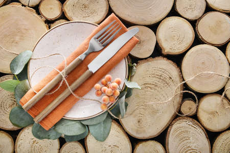 Table setting with floral decor on wooden background