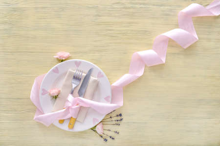 Table setting with floral decor on wooden backgroundの写真素材