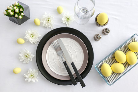 Table setting for Easter celebration on white background