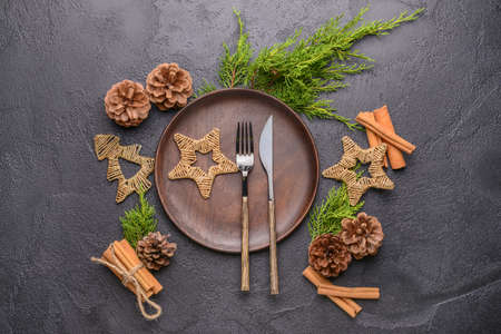 Beautiful table setting for Christmas dinner on dark background