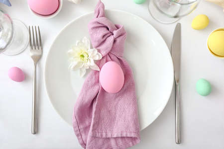 Table setting for Easter celebration on white backgroundの写真素材