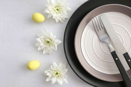 Table setting for Easter celebration on white backgroundの写真素材