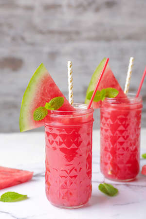 Glasses of fresh watermelon juice on tableの写真素材
