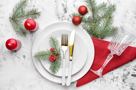 Beautiful table setting for Christmas dinner on light backgroundの写真素材