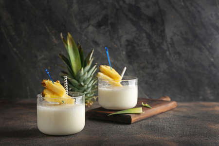 Glasses of tasty Pina Colada cocktail on tableの写真素材