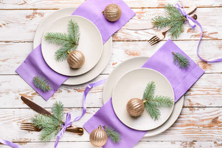 Beautiful table setting for Christmas dinner on wooden background