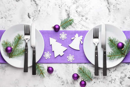 Beautiful table setting for Christmas dinner on light backgroundの写真素材