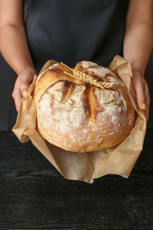 Woman with fresh bread, closeupの写真素材