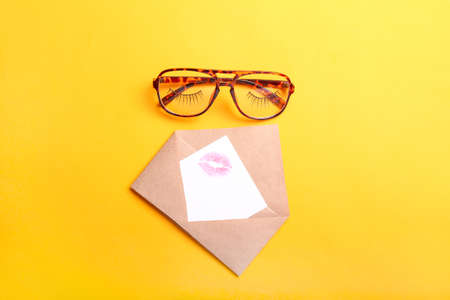 Stylish eyeglasses with envelope and letter on color backgroundの写真素材