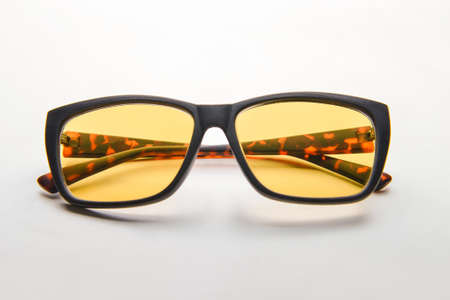 Stylish glasses on light background