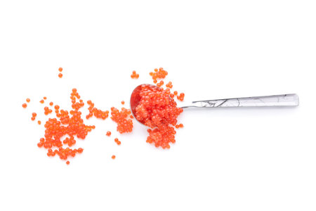 Spoon with red caviar on white backgroundの写真素材