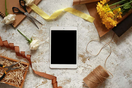 Modern tablet computer on workplace of floristの写真素材