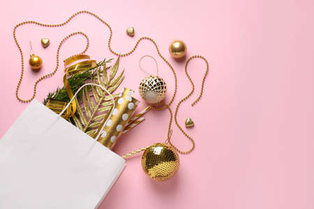 Beautiful composition with shopping bag and Christmas decor on color backgroundの写真素材