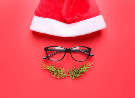 Creative Christmas composition with Santa face on color backgroundの写真素材